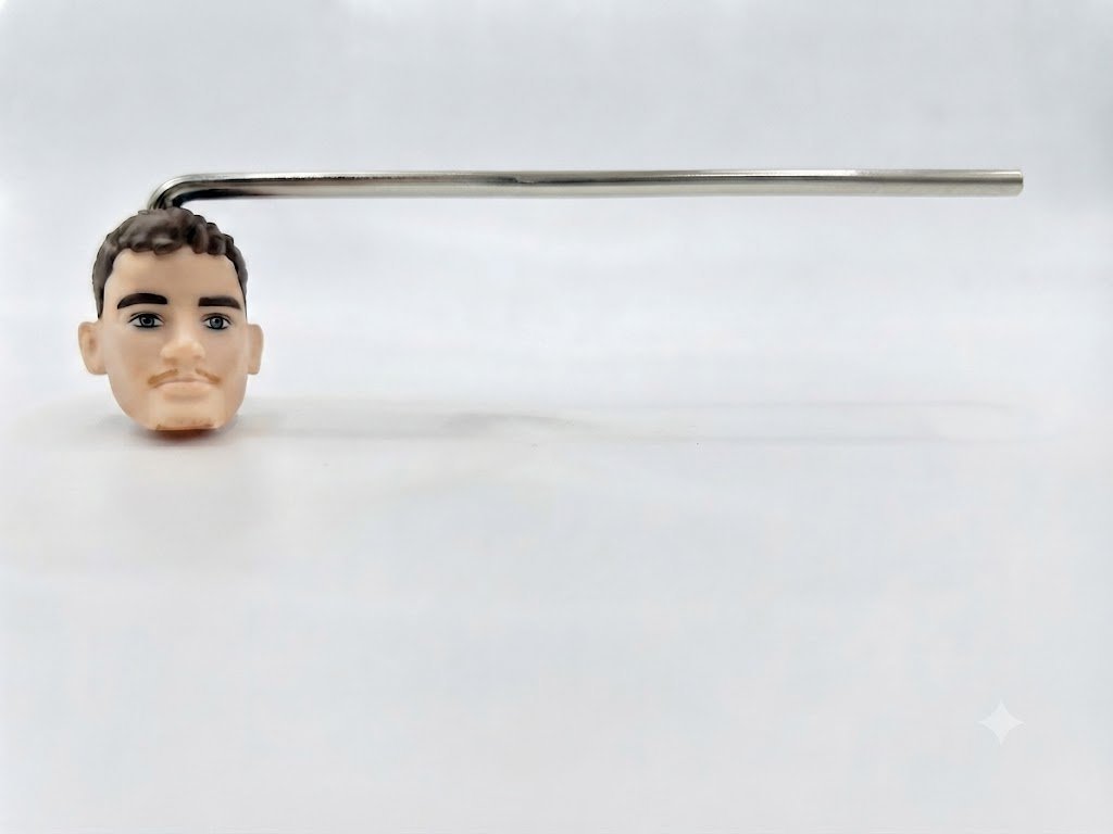 CO·PILOT full unit on a white studio background — plain steel rod with generic plastic doll head attached